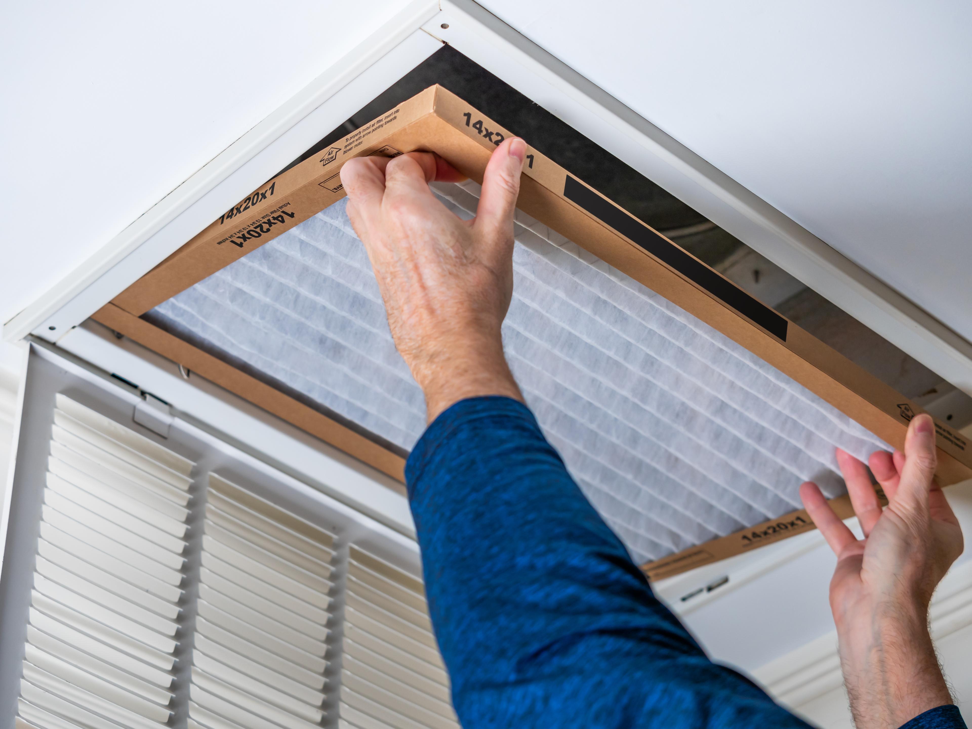 Technician changing a residential air filter